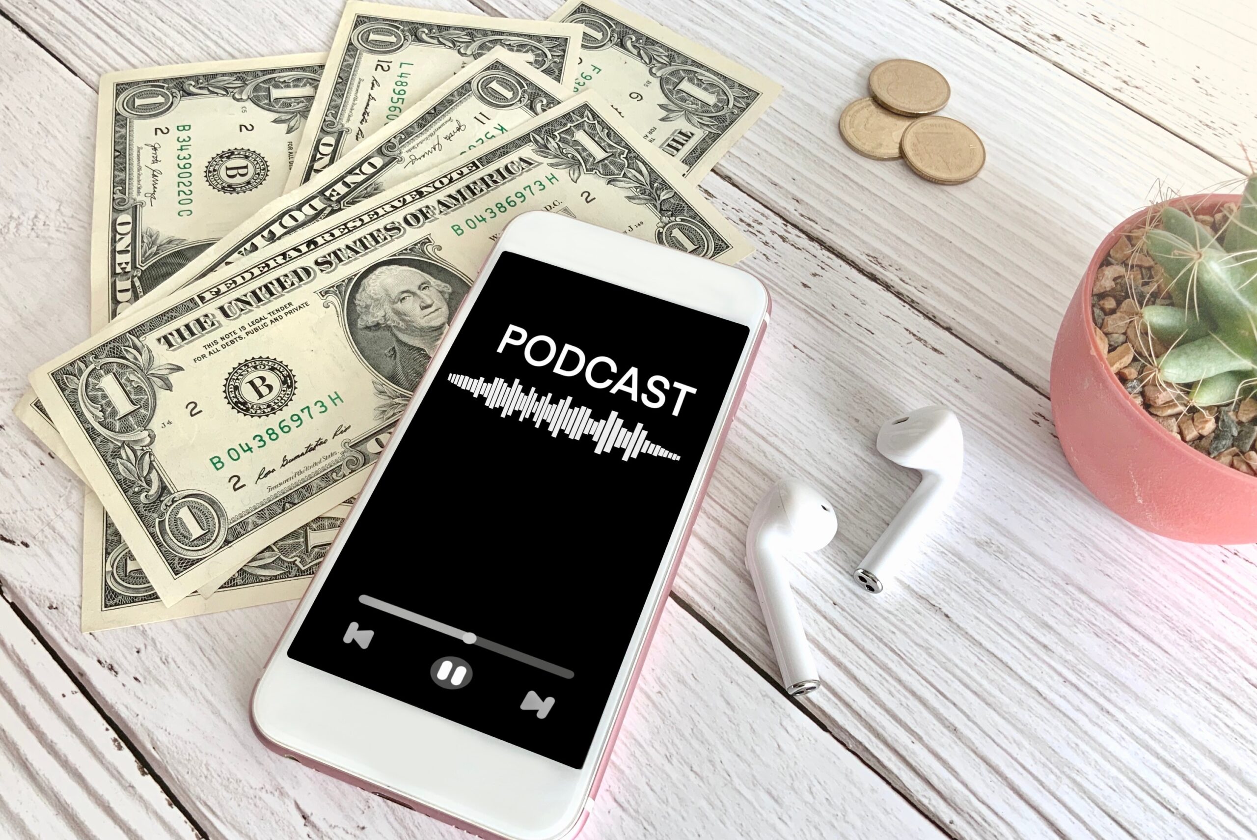 AirPods with money and iPhone.